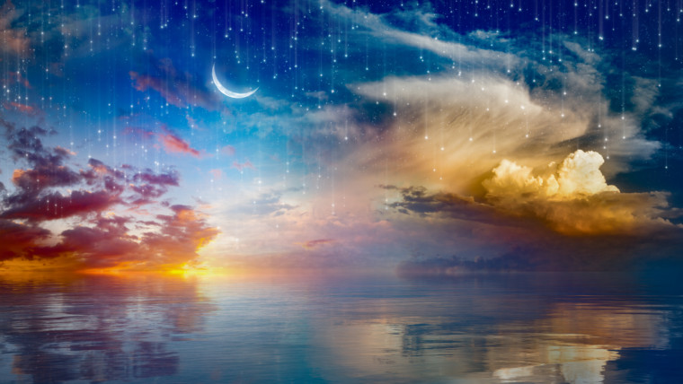 Amazing surreal background - crescent moon rising above serene sea in sunset sky, glowing horizon and falling stars. Elements of this image furnished by NASA