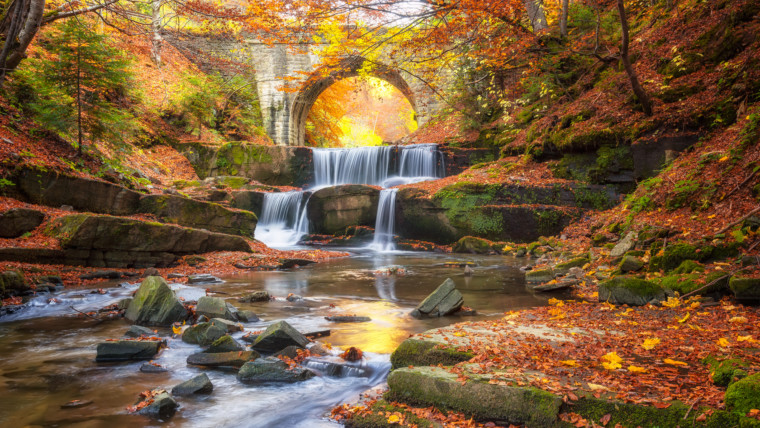 Autumn fairytale by the river / Autumn river with beautiful cascades of water and an old bridge near Sitovo village, Bulgaria